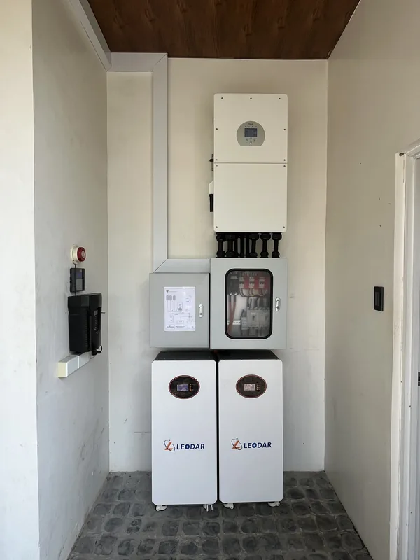 Hybrid inverter, protection enclosures and two battery cabinets in a wall niche
